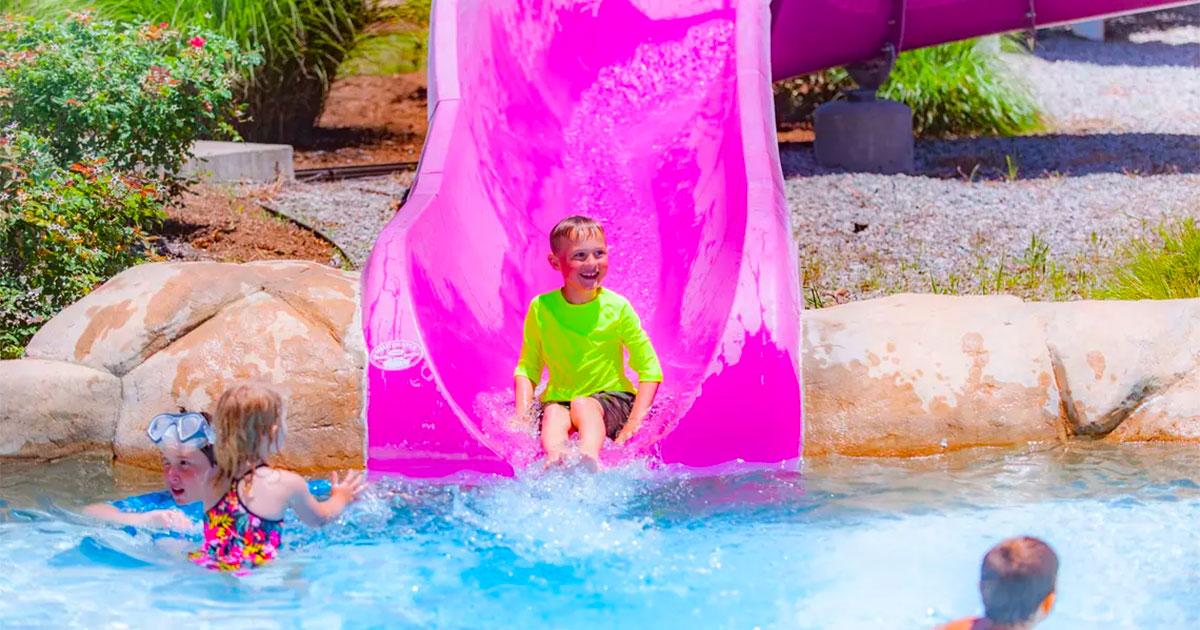 boy in yellow on purple slide