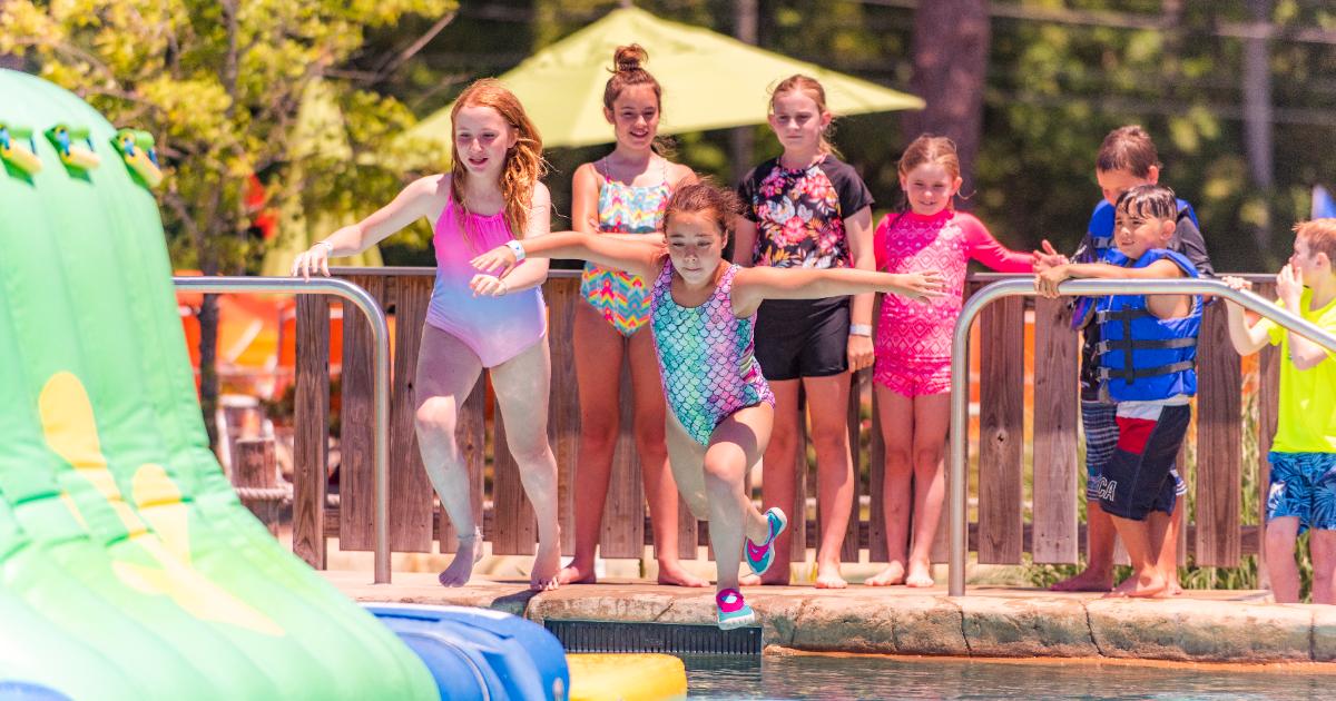 Girl in mermaid bathing suit jumping