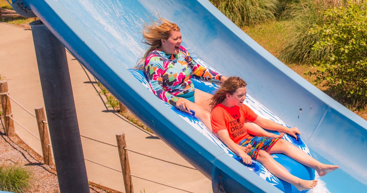 Mother in back, boy in orange in front