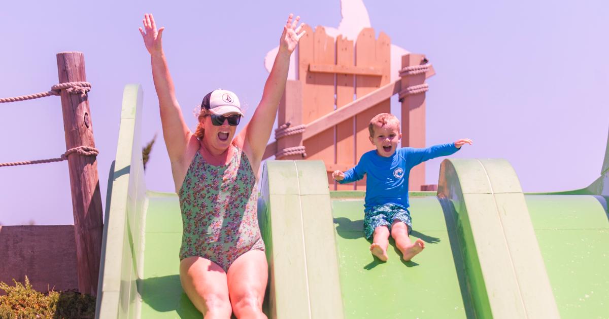 mother and boy in blue with hands up