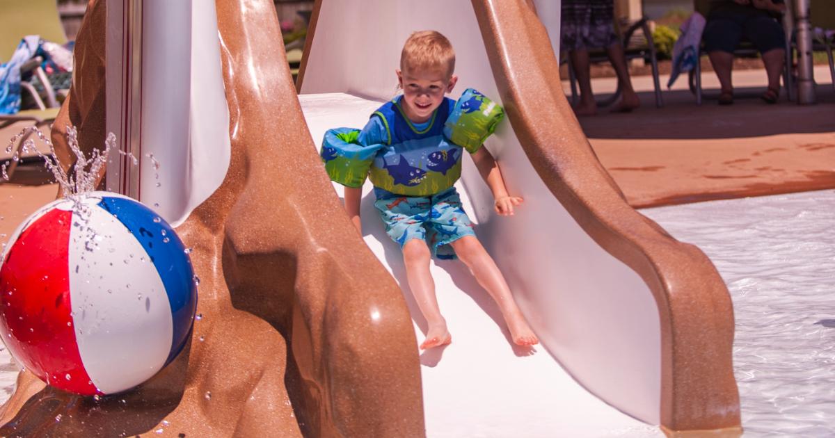 Boy sliding down slide