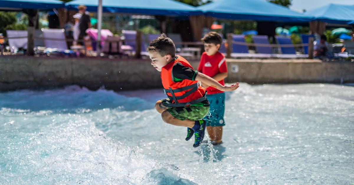 Kid in life jacket jumping 