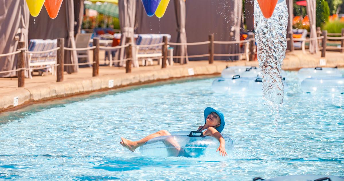 Lady in hat floating in the Lazy River