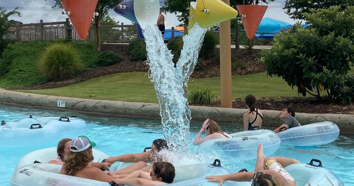 Group of people under waterfalls on river