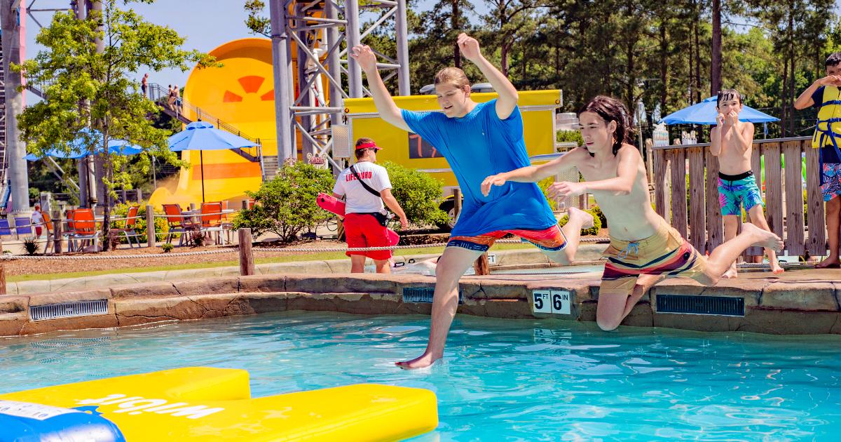 Boys jumping on obstacle