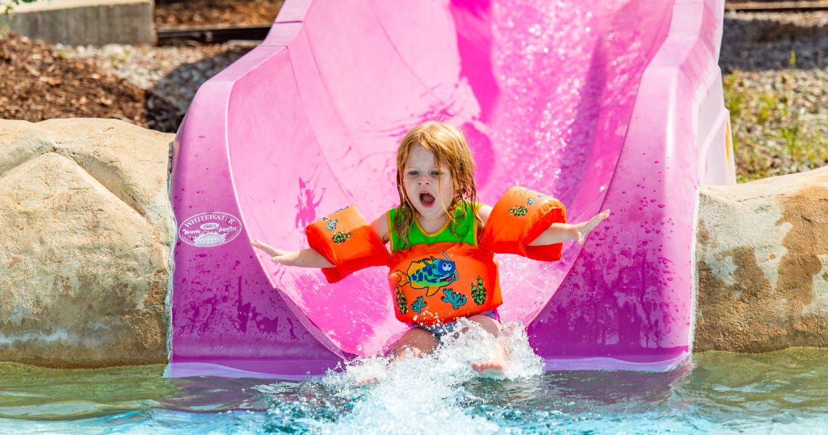 Girl with floaties on purple slide