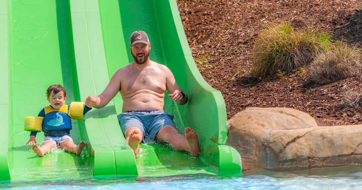 Father and son on green slide