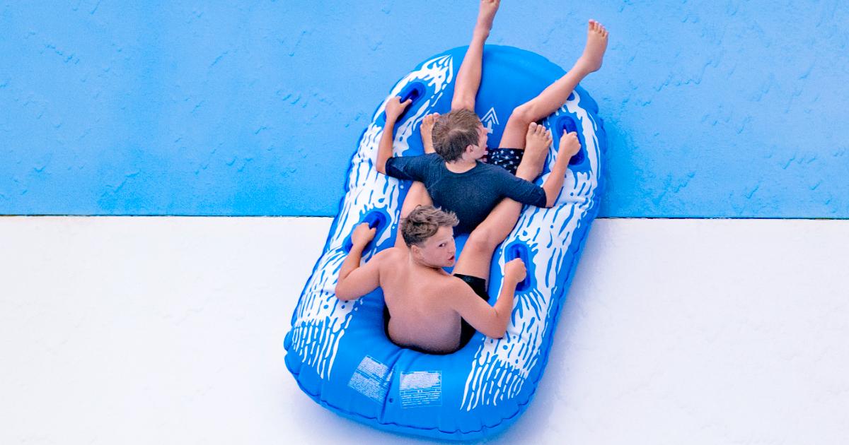 two males on blue raft